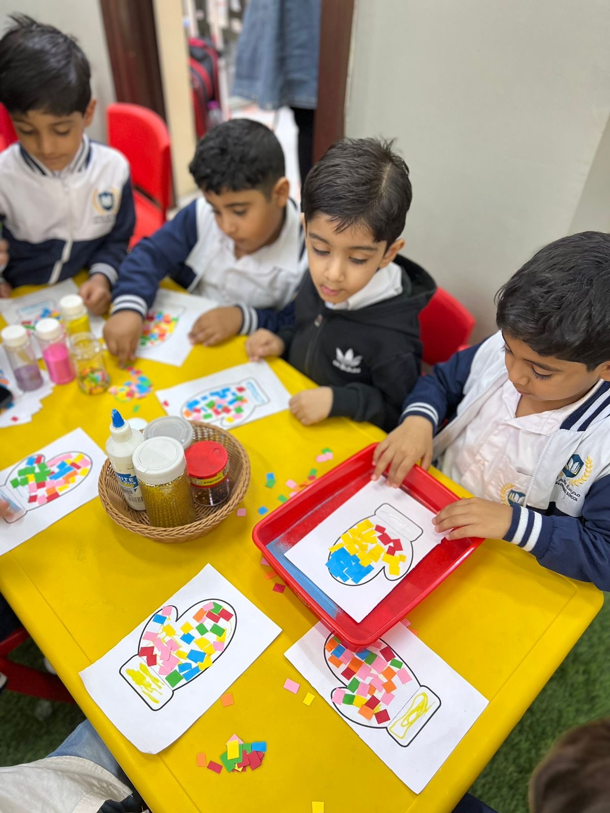 Teacher with kindergarten children in a colorful classroom